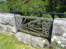 Blacksmith Chris Topp's train is one of eight decorative ironwork panels on the viaduct's parapet, recalling the steam trains that once crossed the burn here.