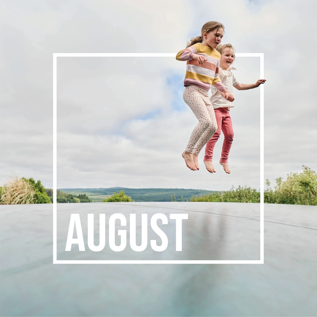 August image of two girls jumping on trampoline